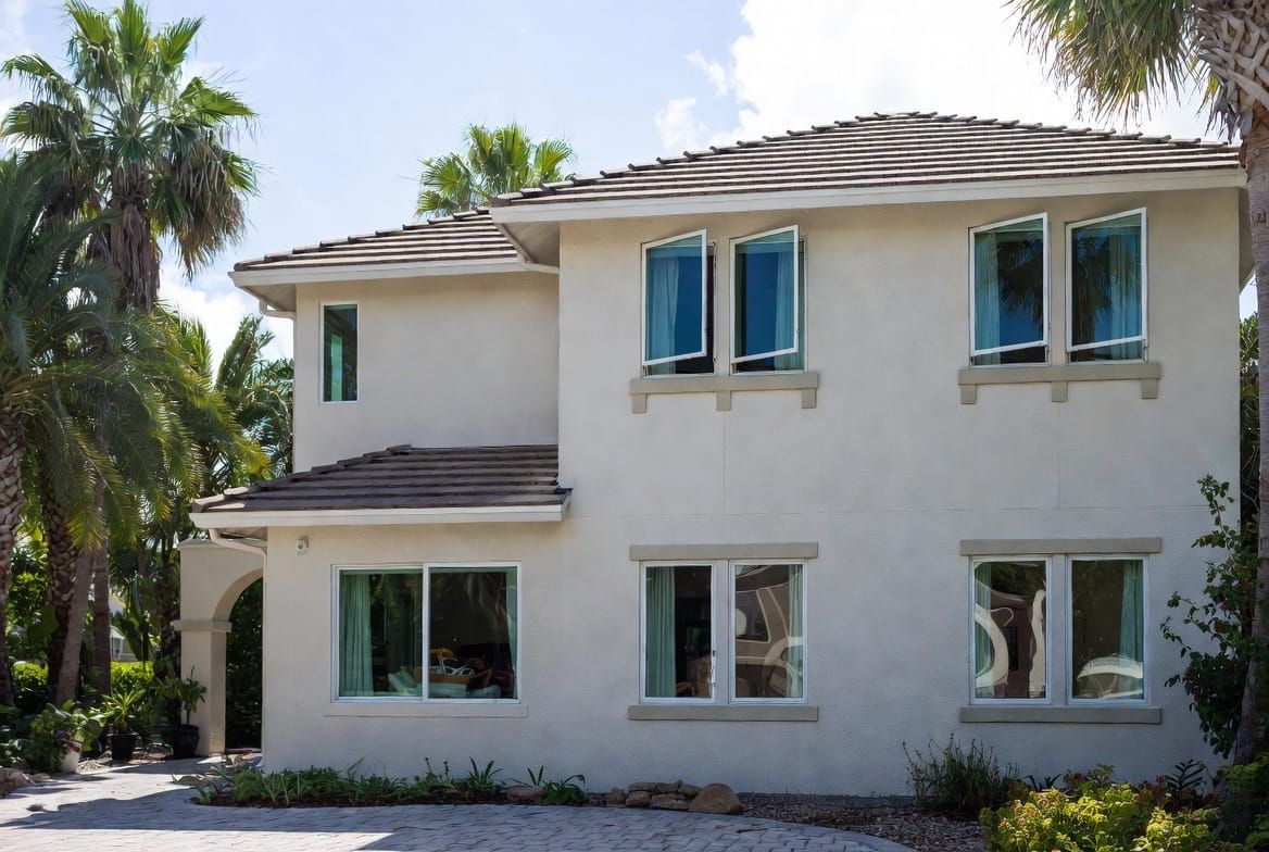 Completed impact window installation on South Florida home with palm trees